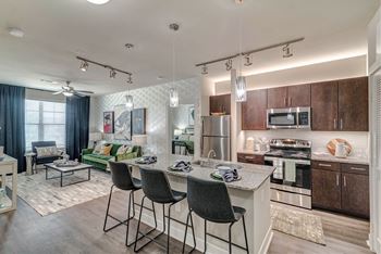 A modern kitchen with dark wood cabinets and a white island.